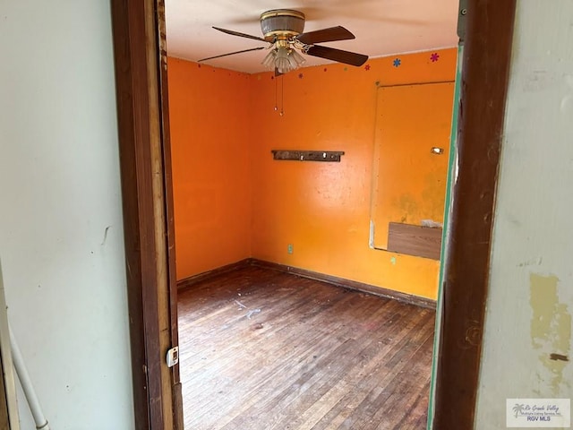 unfurnished room with ceiling fan and wood-type flooring