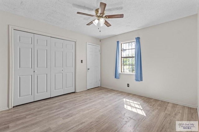 419 Mockingbird St, San Benito, TX 78586 - unfurnished bedroom with wood finished floors, a textured ceiling, a closet, and ceiling fan