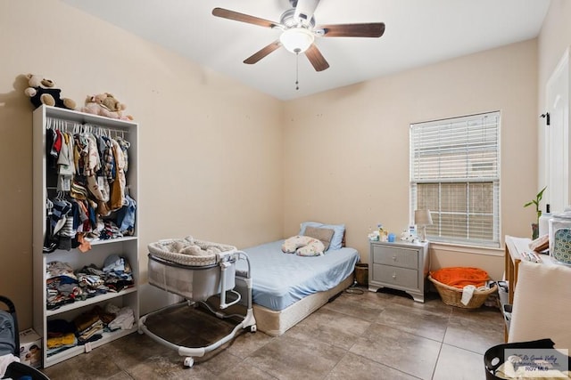 bedroom featuring tile patterned flooring, a closet, and ceiling fan