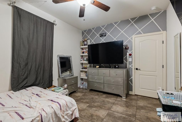 bedroom featuring ceiling fan and tile walls