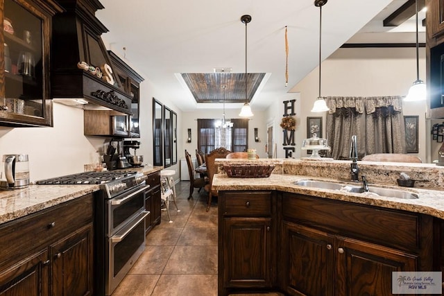 kitchen featuring high end range, sink, hanging light fixtures, dark brown cabinets, and a chandelier