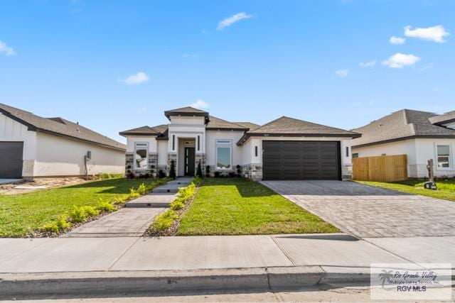 view of front of house with a garage and a front yard