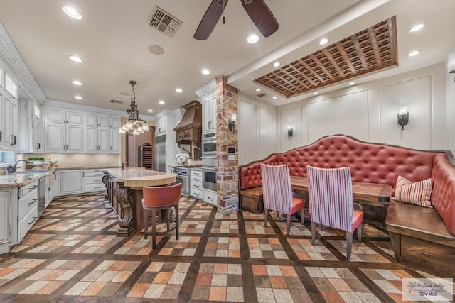 dining space with crown molding and ceiling fan