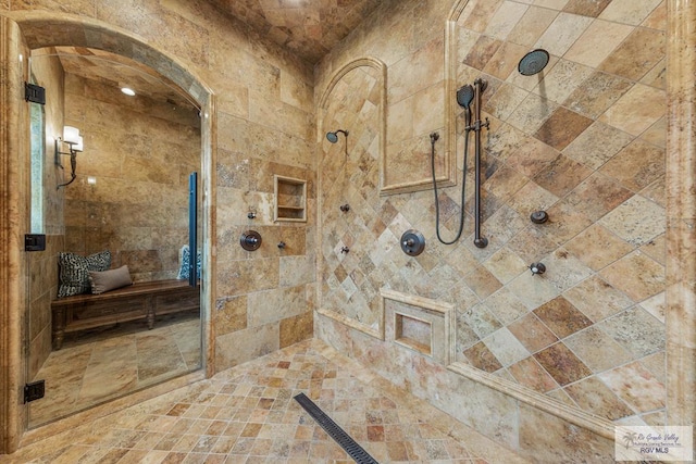 bathroom with tiled shower