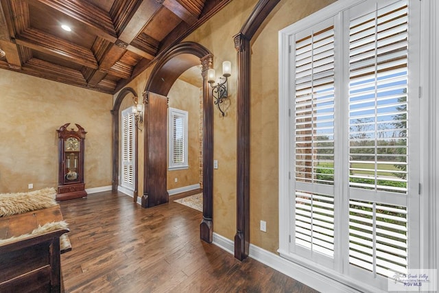 interior space featuring beamed ceiling, crown molding, coffered ceiling, and dark hardwood / wood-style floors