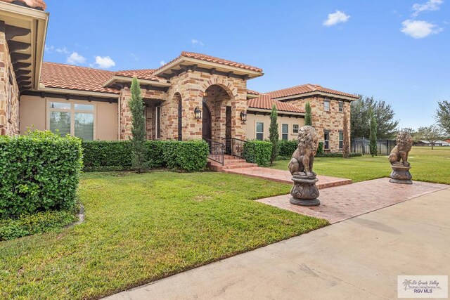 mediterranean / spanish-style house with a patio and a front lawn