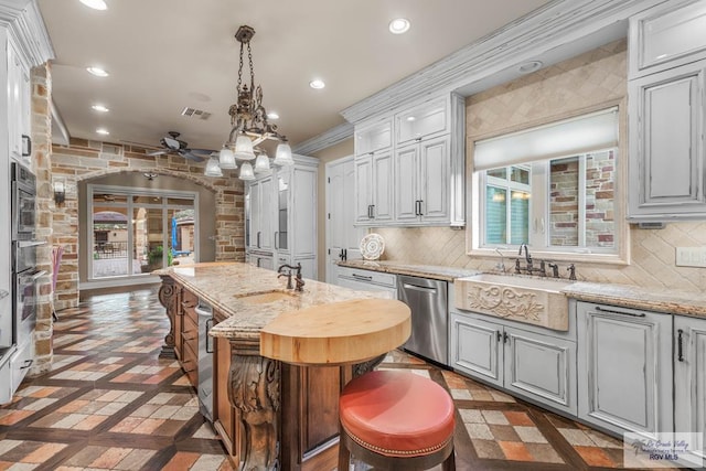 kitchen featuring white cabinetry, sink, light stone countertops, and appliances with stainless steel finishes