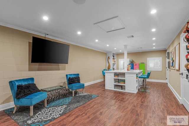 living area featuring dark hardwood / wood-style flooring and ornamental molding