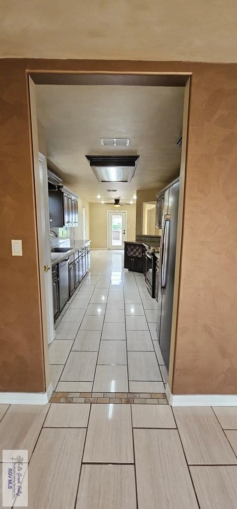 1626 N Shore Dr, Port Isabel, TX 78578 - hallway featuring a sink and baseboards
