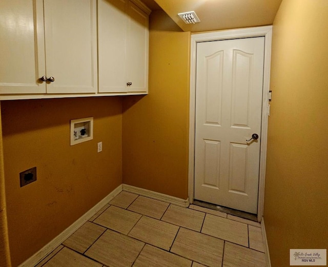1626 N Shore Dr, Port Isabel, TX 78578 - clothes washing area with cabinet space, hookup for an electric dryer, hookup for a washing machine, and baseboards