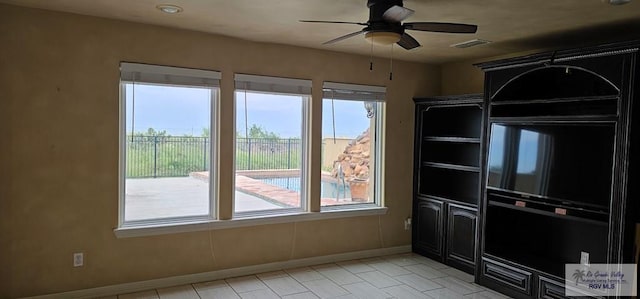 1626 N Shore Dr, Port Isabel, TX 78578 - unfurnished dining area featuring a ceiling fan, baseboards, and light tile patterned flooring