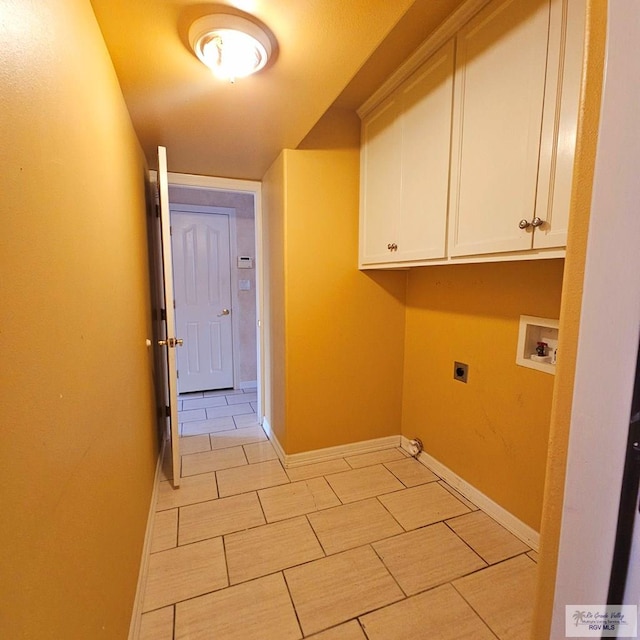 1626 N Shore Dr, Port Isabel, TX 78578 - laundry room featuring electric dryer hookup, hookup for a washing machine, cabinet space, light tile patterned floors, and baseboards