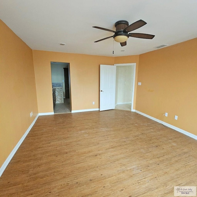 1626 N Shore Dr, Port Isabel, TX 78578 - spare room with wood finished floors, a ceiling fan, and baseboards