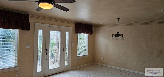 1626 N Shore Dr, Port Isabel, TX 78578 - tiled entrance foyer with plenty of natural light, ceiling fan, baseboards, and crown molding