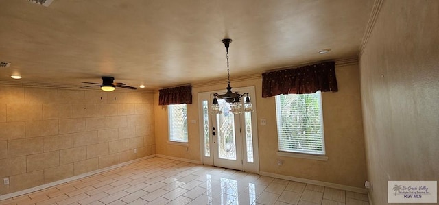 1626 N Shore Dr, Port Isabel, TX 78578 - tiled foyer entrance with ornamental molding, baseboards, ceiling fan, and a chandelier