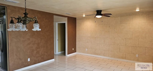 1626 N Shore Dr, Port Isabel, TX 78578 - empty room with a ceiling fan, light tile patterned flooring, and baseboards