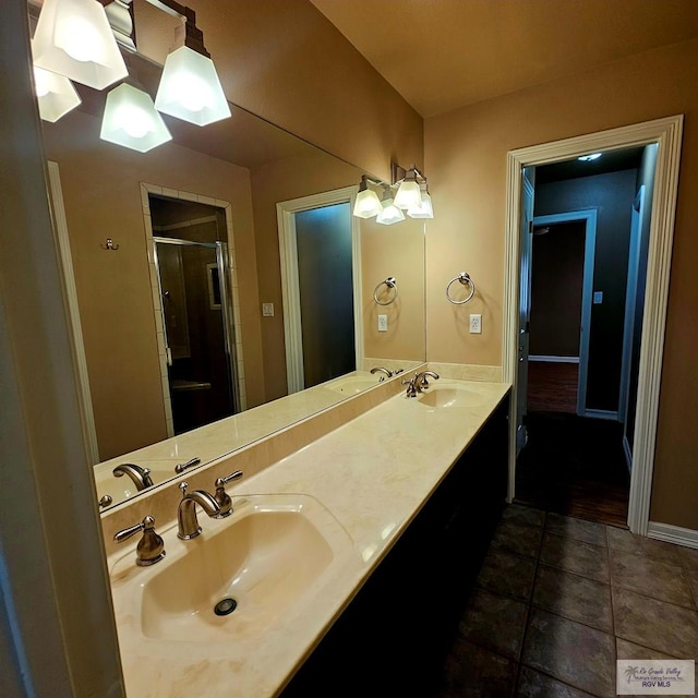 1626 N Shore Dr, Port Isabel, TX 78578 - bathroom with a stall shower, double vanity, baseboards, and tile patterned floors