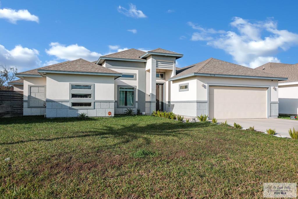 view of front facade with a front yard and a garage