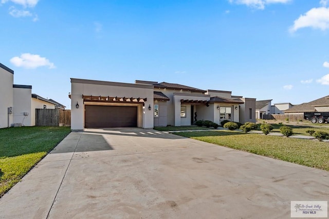 view of front facade featuring a garage and a front lawn