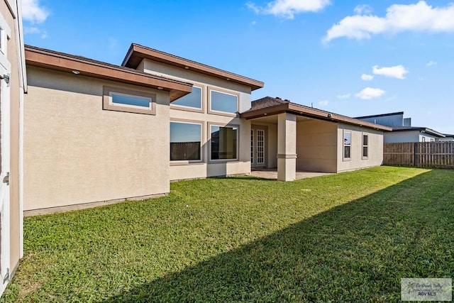 back of house with a yard and a patio area