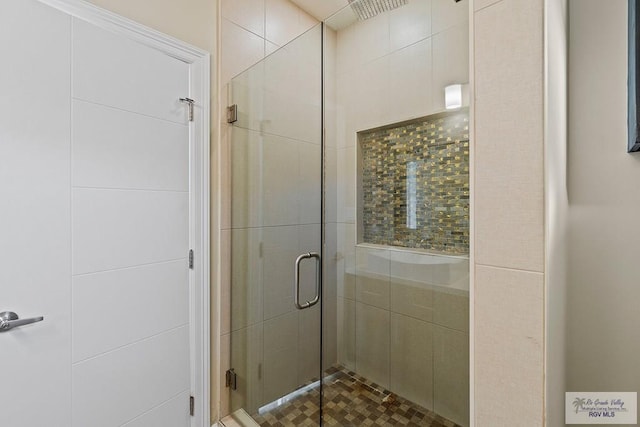 bathroom with a shower with shower door