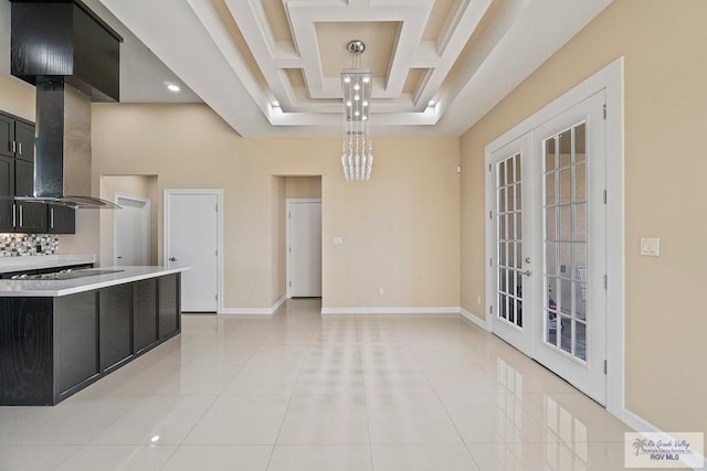 kitchen with extractor fan, light tile patterned flooring, a high ceiling, coffered ceiling, and french doors