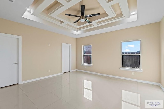 tiled spare room with ceiling fan and coffered ceiling