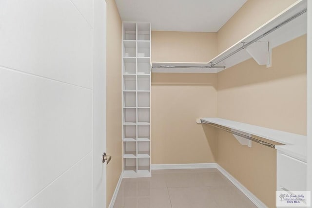 spacious closet with light tile patterned flooring