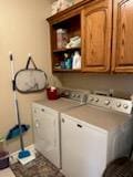 washroom with cabinets and washer and clothes dryer