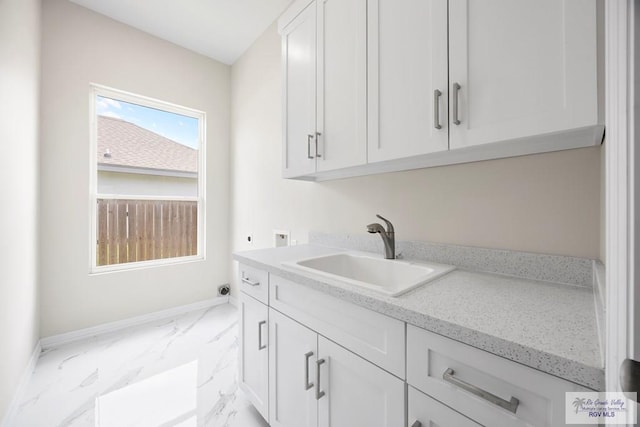 5359 Sidekick Ave, Brownsville, TX 78526 - washroom with light marble finish flooring, hookup for a washing machine, and cabinet space