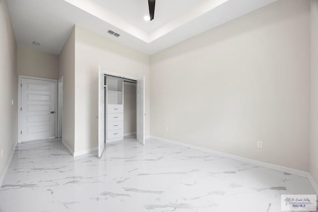 5359 Sidekick Ave, Brownsville, TX 78526 - unfurnished bedroom with light marble finish floors, a closet, a raised ceiling, and recessed lighting