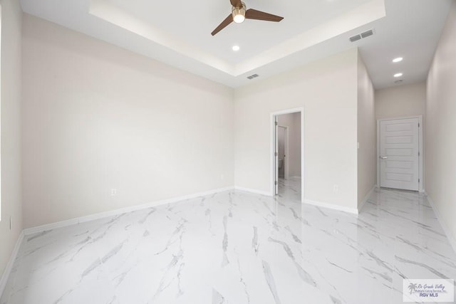5359 Sidekick Ave, Brownsville, TX 78526 - unfurnished room featuring a tray ceiling, a ceiling fan, recessed lighting, and light marble finish floors