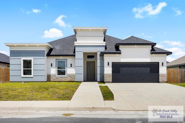 5359 Sidekick Ave, Brownsville, TX 78526 - modern home featuring stone siding, stucco siding, an attached garage, and driveway