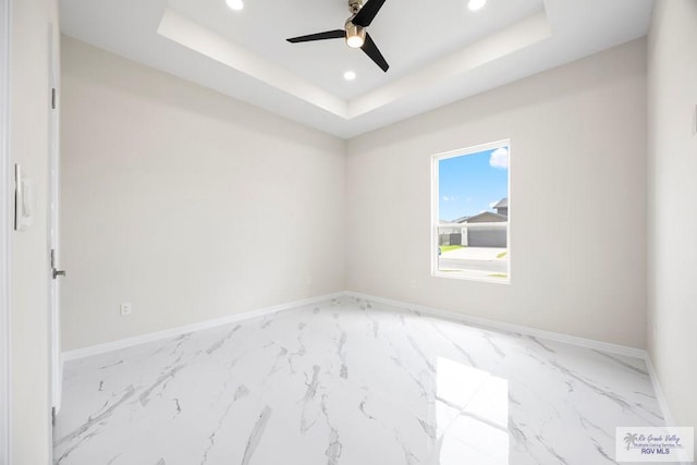 5359 Sidekick Ave, Brownsville, TX 78526 - empty room with marble look tiles, recessed lighting, ceiling fan, and a raised ceiling