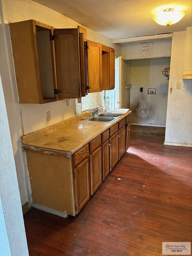 821 Virginia Ave, La Feria, TX 78559 - kitchen featuring dark wood-style floors, brown cabinets, and light countertops