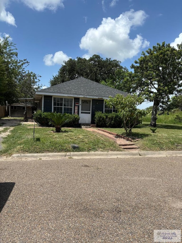 821 Virginia Ave, La Feria, TX 78559 - view of front of property featuring a front yard and roof with shingles