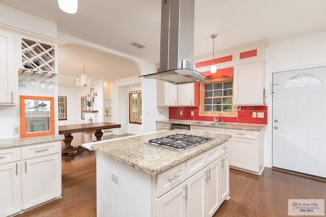 701 S Parker Rd, La Feria, TX 78559 - kitchen with a sink, island exhaust hood, dark wood-type flooring, backsplash, and appliances with stainless steel finishes