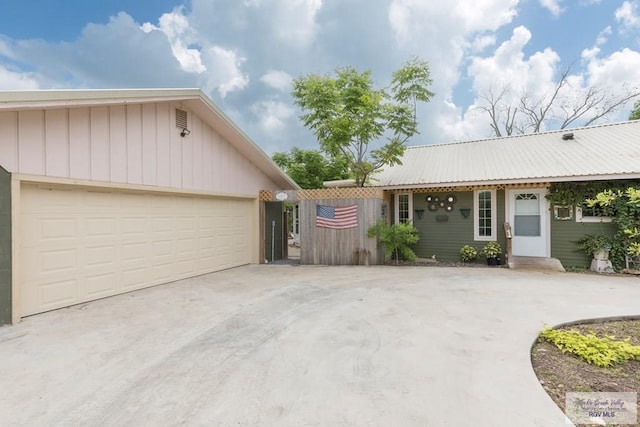 701 S Parker Rd, La Feria, TX 78559 - view of front facade with a garage, metal roof, and concrete driveway