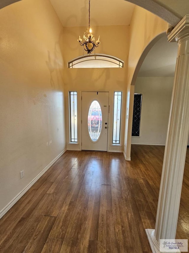 2884 Gibraltar St, Brownsville, TX 78520 - entryway with arched walkways, wood finished floors, a chandelier, decorative columns, and baseboards