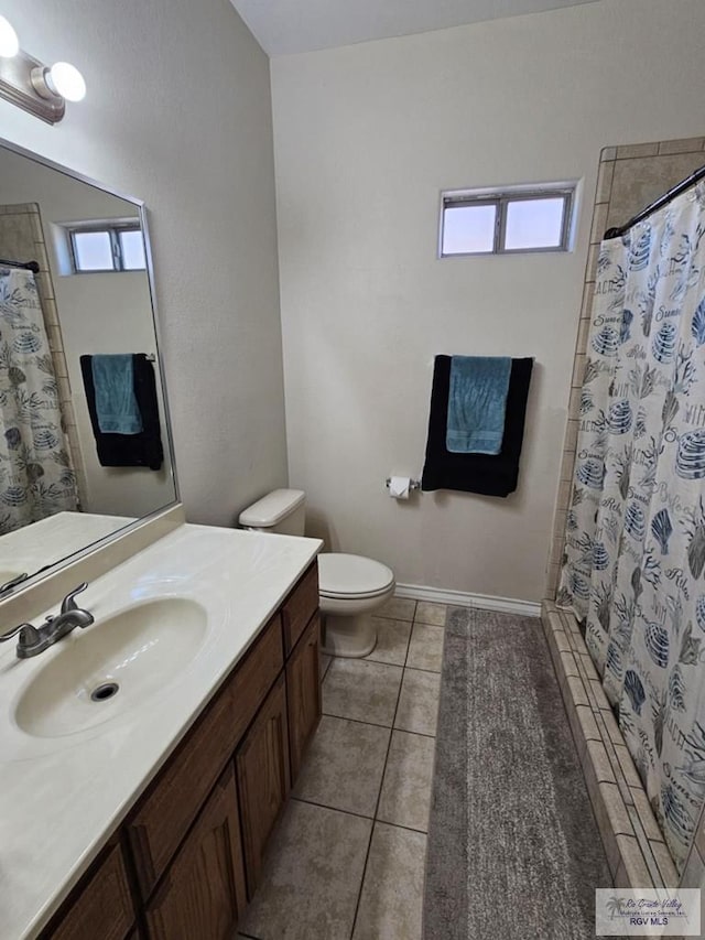 2884 Gibraltar St, Brownsville, TX 78520 - bathroom featuring healthy amount of natural light, tile patterned floors, toilet, and vanity