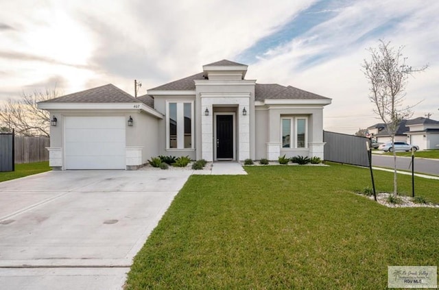 view of front of home featuring a garage and a front yard