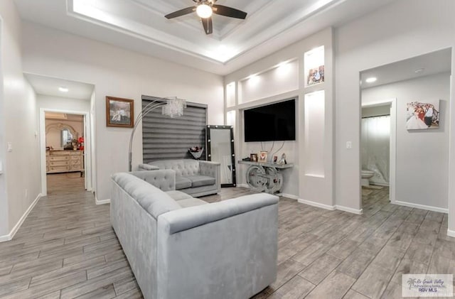 living room with ceiling fan and light hardwood / wood-style flooring