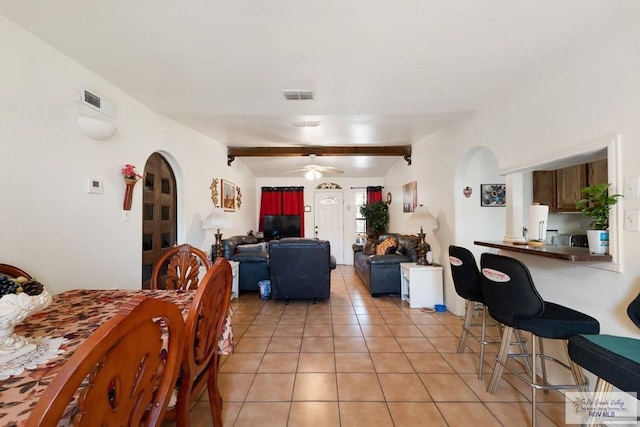 dining space with beamed ceiling, ceiling fan, and light tile patterned floors