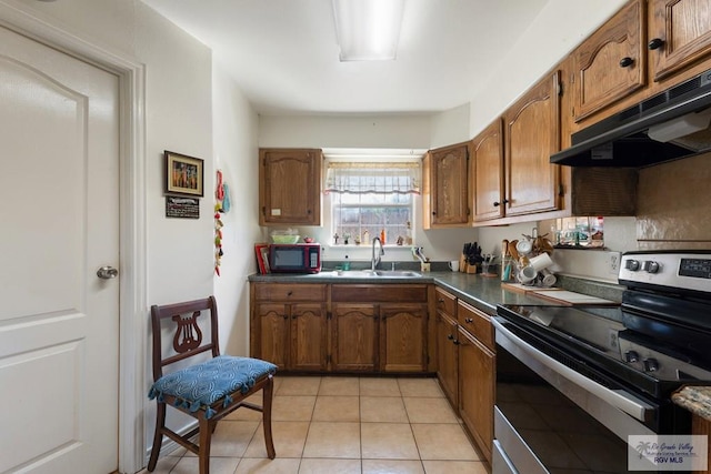 kitchen with sink, light tile patterned floors, stainless steel range with electric cooktop, and range hood