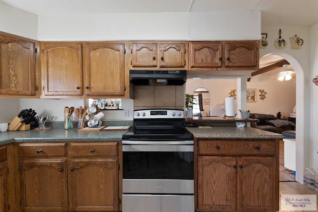 kitchen with light tile patterned floors, stainless steel electric range oven, ceiling fan, and exhaust hood