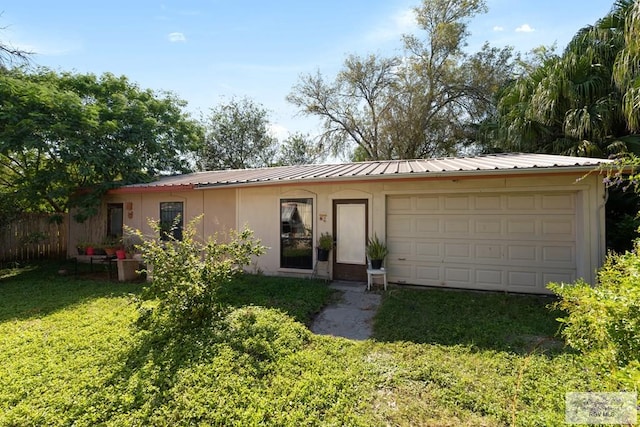 ranch-style home featuring a front yard and a garage