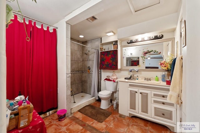 bathroom featuring tile patterned floors, vanity, toilet, and walk in shower