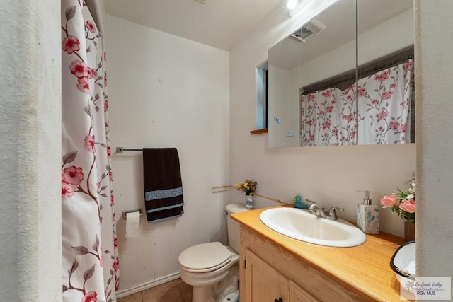 bathroom with tile patterned floors, vanity, curtained shower, and toilet