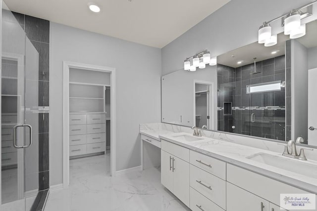 bathroom featuring vanity and a shower with door