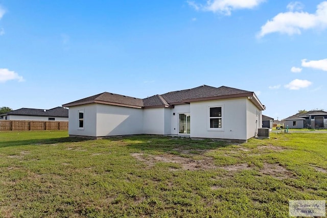 back of house with a yard and central AC